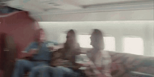 a blurry picture of people sitting on a plane