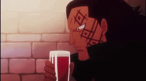 a man with a tattoo on his forehead is drinking from a glass