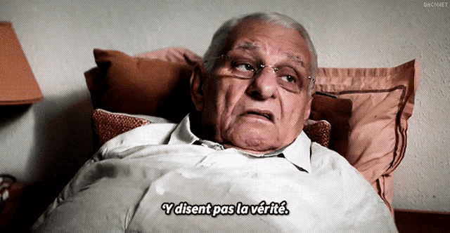 an elderly man is laying in bed with the words " y disent pas la verite " below him