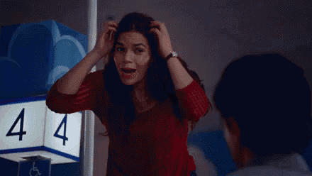 a woman in a red shirt is scratching her head in front of a sign that says a4 .