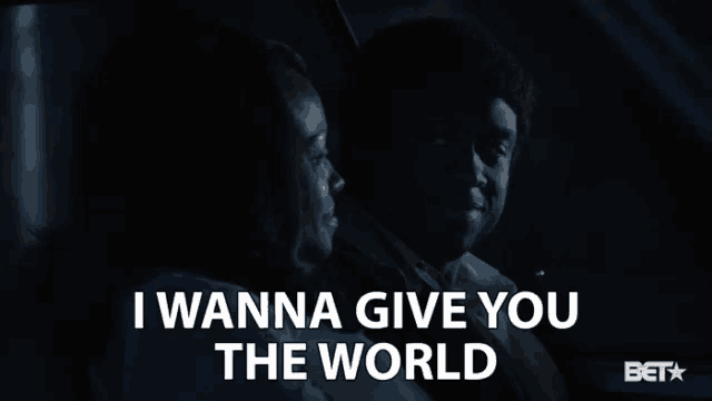 a man and woman are sitting in a car with the words i wanna give you the world