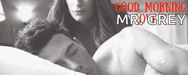 a black and white photo of a man and a woman in bed .