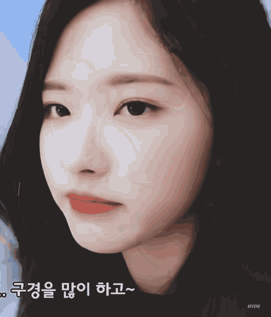 a close up of a woman 's face with korean writing on the bottom right
