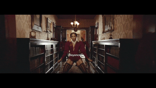 a woman in a red jacket is running down a hallway with jayonce written on the bottom of the screen