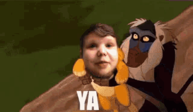 a young boy is standing next to a monkey with the words `` ya '' written on it .