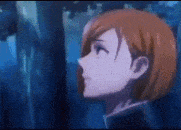 a close up of a girl 's face in a forest .