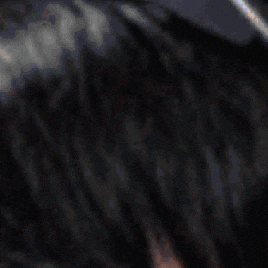 a close up of a person 's eye and hair