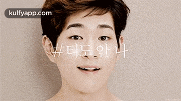 a young man is smiling with his hand on his forehead .