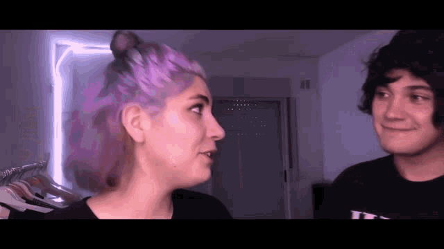 a man and a woman are looking at each other