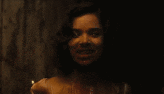 a close up of a woman 's face with blood coming out of it .
