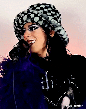 a woman wearing a black and white checkered hat