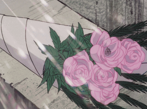 a bouquet of pink roses and green leaves is wrapped in white paper