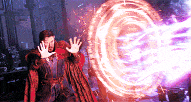 a man in a red cape is holding his hands up in front of a circle of fire