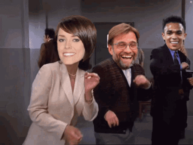 a woman and two men are dancing together with their faces on their heads