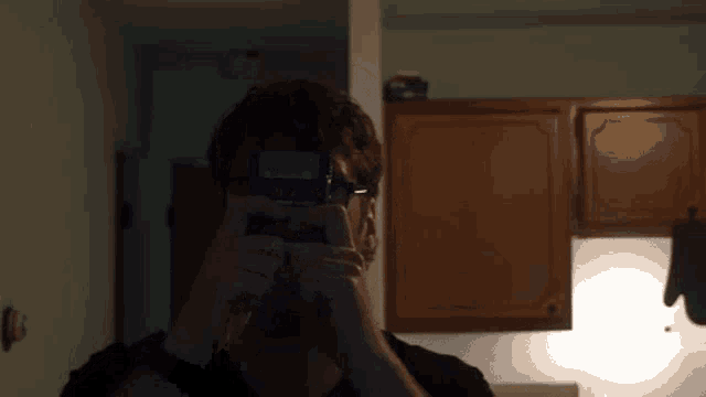 a man is taking a picture of himself in a mirror