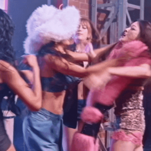 a group of women are having a fight in a club .