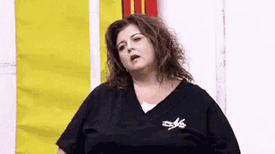a woman in a black shirt is making a funny face .