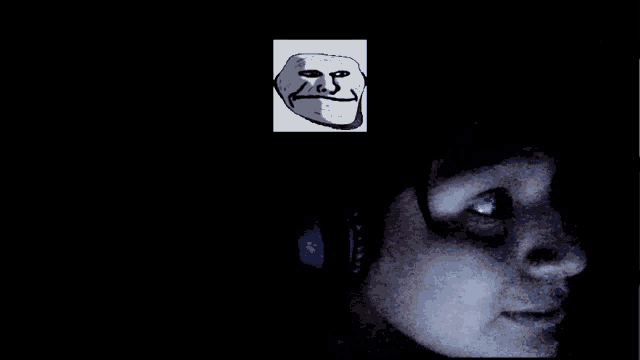 a drawing of a troll face is on a black background