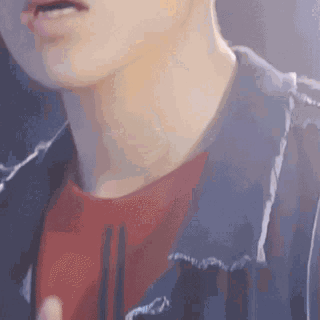 a close up of a man 's neck and chest wearing a blue jacket and a red shirt .
