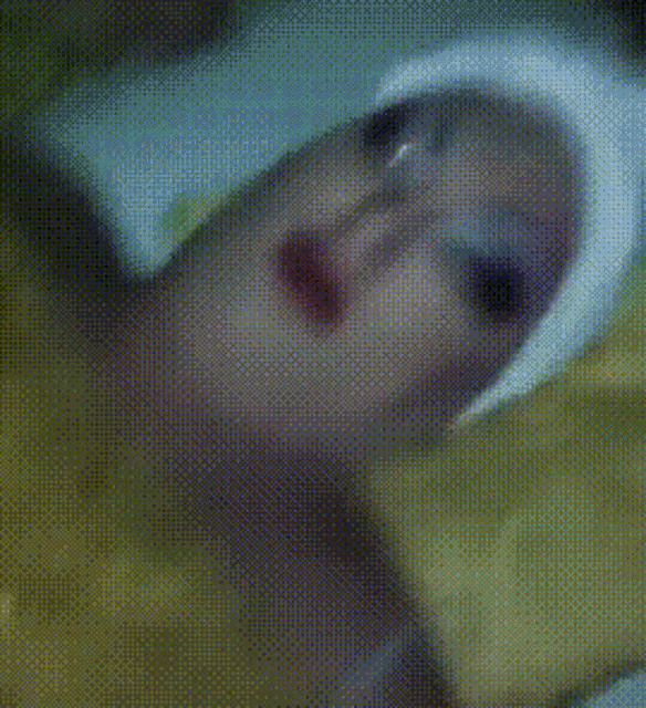 a close up of a person 's face with a towel on their head