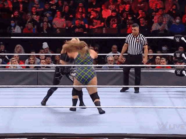 a referee in a wrestling ring with the word live on the bottom right