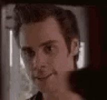 a close up of a man 's face looking at the camera and smiling .