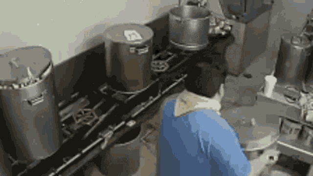 a man is cooking in a kitchen with pots and pans