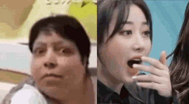 a man and a woman are sitting next to each other . the woman is eating a cherry .