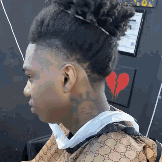 a man with a bun and a tattoo on his neck