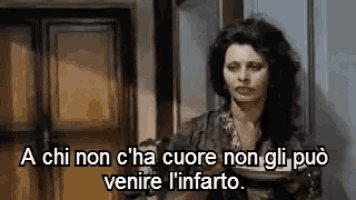 a woman is standing in front of a door with a plate in her hand and a quote in another language .