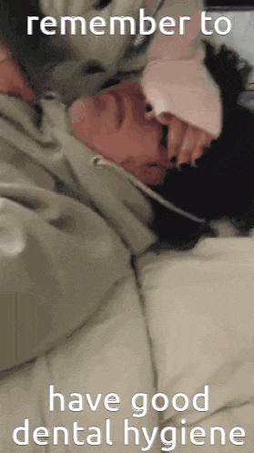 a man is laying on a bed with the words remember to have good dental hygiene