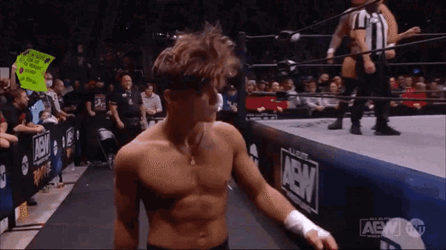 a man in a wrestling ring with a sign that says " i love you " on it