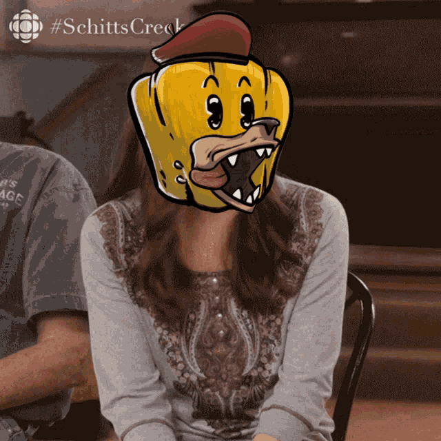 a woman wearing a mask with a cartoon duck face on it