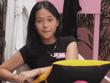 a girl wearing a black shirt with the word rain on the front
