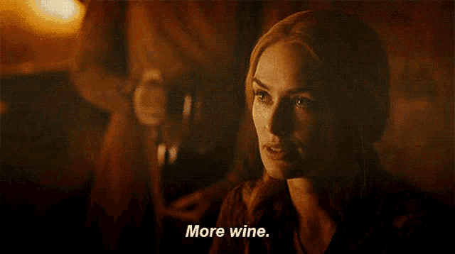 a woman is holding a glass of wine and says " more wine "