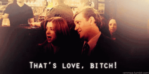 a man and woman are standing next to each other with the words that 's love bitch