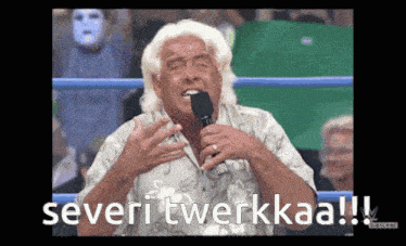 a man in a wrestling ring holds a microphone and says severi twerkkaa !!