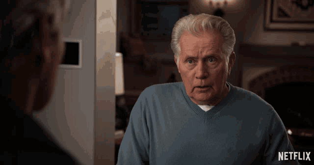 an older man in a blue sweater is looking at another man in a netflix ad