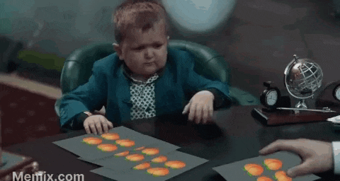 a person 's hand is touching a sheet of paper with peaches on it .