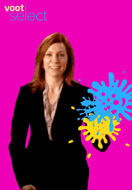 a woman in a suit stands in front of a pink background with the word voot select on it
