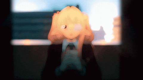 a blurred image of a person holding their head with a light shining on it