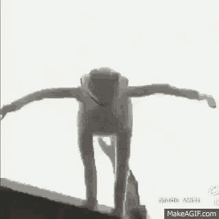 a black and white photo of a person walking through a doorway in a house .