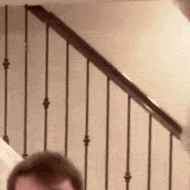 a close up of a person standing on a set of stairs .