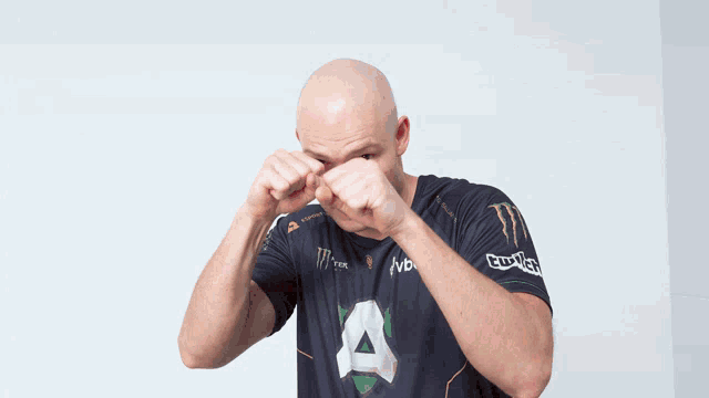 a man wearing a black shirt with a monster logo on it
