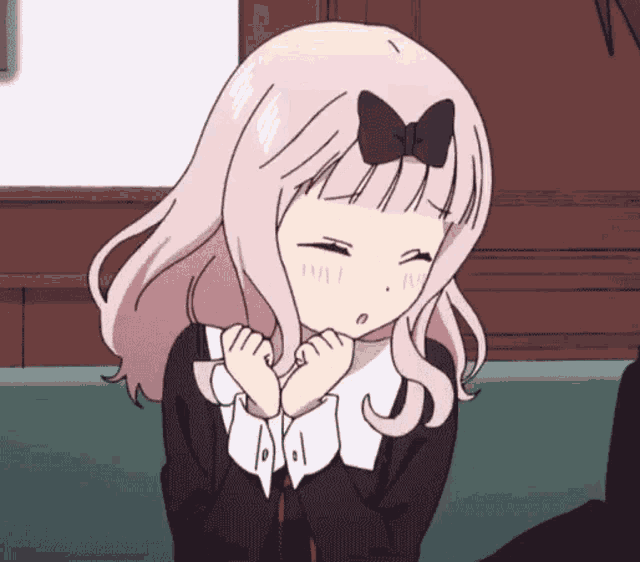a girl with a bow in her hair is making a face