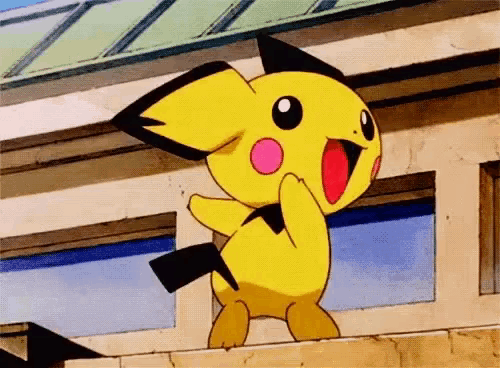 a yellow cartoon character with a black tail is standing on a wall .
