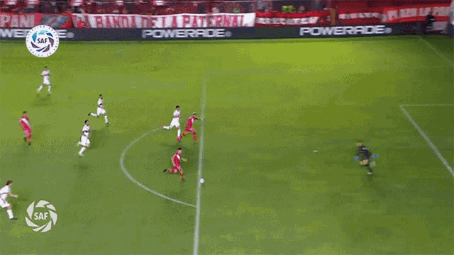 a soccer game is being played on a field with powerade advertisements