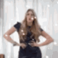 a blurry picture of a woman standing in front of a mirror .
