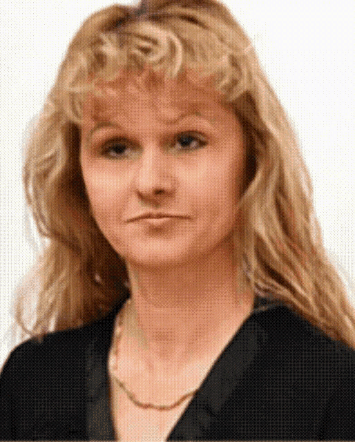 a woman with blonde hair wearing a black shirt and a necklace