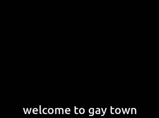 a welcome to gay town sign is displayed in front of a city skyline